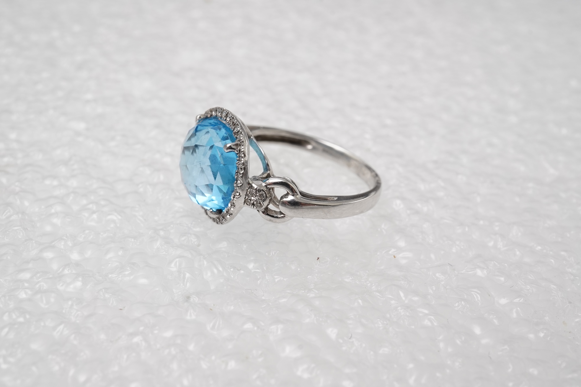 A blue topaz and diamond ring